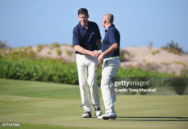 Calum Callan of Cottesmore Golf Club and Trevor Pigram, Captain of Cottesmore Golf Club shake hands as they finish their first round on the 18th...