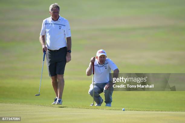 Andrew Baguley of Leigh Golf Club and John Taylor, Captain of Leigh Golf Club line up a putt on the 14th green during Day One of the SkyCaddie PGA...