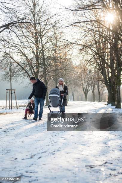 family in winter - stroller stock pictures, royalty-free photos & images