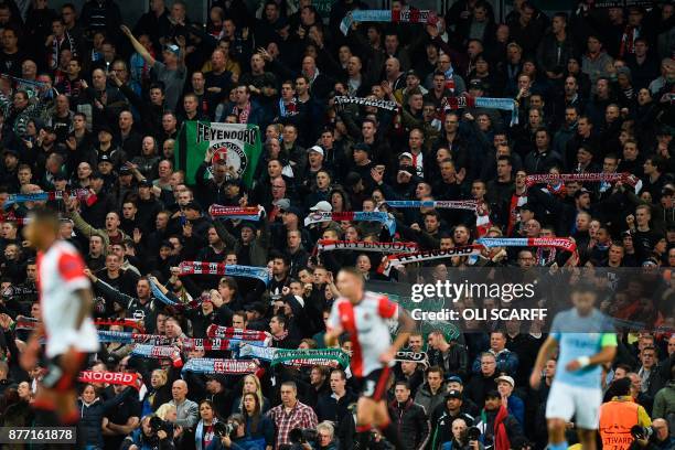 Feyenoord fans wave their scarves in the crowd during the UEFA Champions League Group F football match between Manchester City and Feyenoord at the...