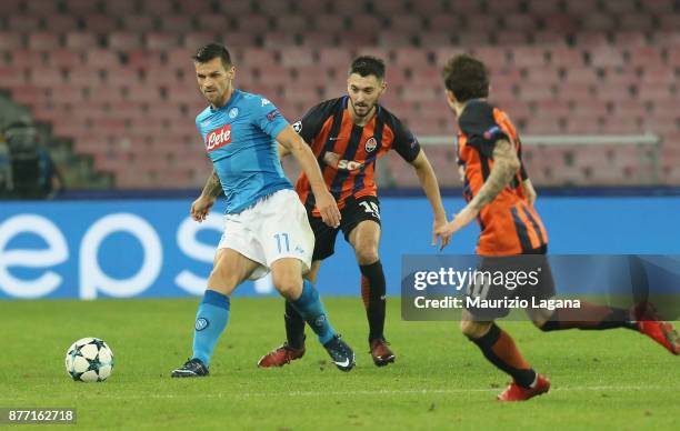 Christian Maggio of Napoli competes for the ball with Ivan Ordets of Shakhtar Donetsk during the UEFA Champions League group F match between SSC...
