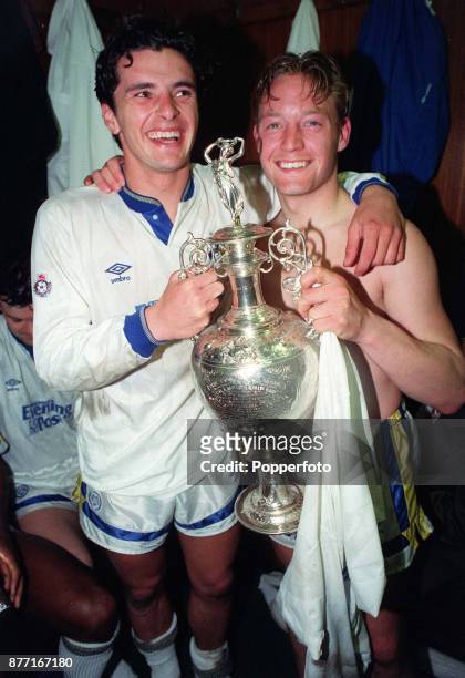 Gary Speed and David Batty holding the Football League Division One Championship trophy as Leeds United celebrate in the dressing room at Elland Road...