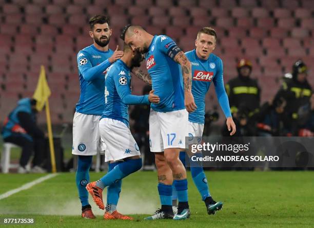 Napoli's midfielder from Italy Lorenzo Insigne celebrates with teammates Napoli's defender from Albania Elseid Hysaj , Napoli's midfielder from...