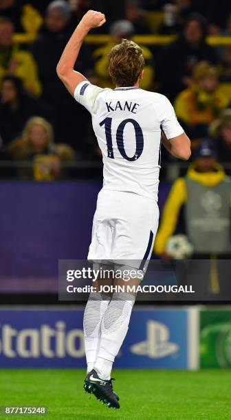 Tottenham Hotspur's English striker Harry Kane celebrates scoring during the UEFA Champions League Group H football match BVB Borussia Dortmund v...