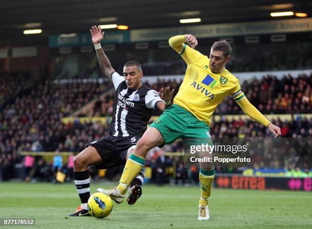 Grant Holt of Norwich City battles with Danny Simpson of Newcastle United during a Barclays Premier League match at Carrow Road on December 10, 2011...