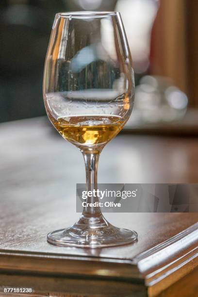 glass for whiskey tasting visit filled with whiskey - whiskey tasting stock pictures, royalty-free photos & images