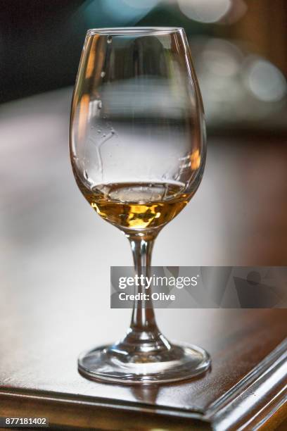 glass for whiskey tasting visit filled with whiskey - whiskey tasting stock pictures, royalty-free photos & images
