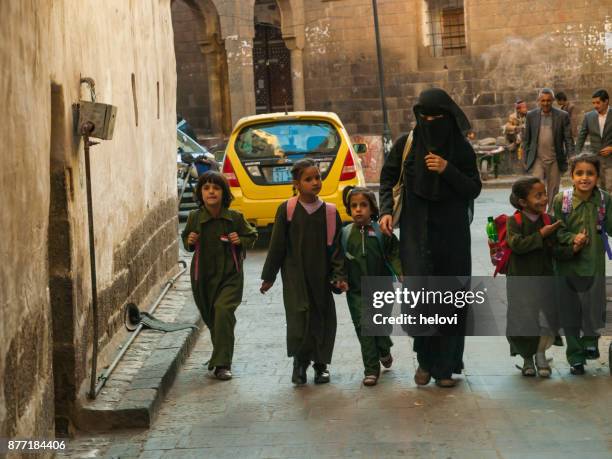 woman in black dress with small children - yemen people stock pictures, royalty-free photos & images