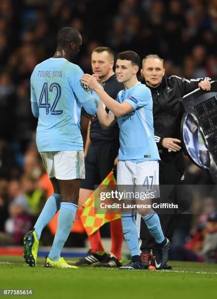 Yaya Toure of Manchester City and Phil Foden of Manchester City shake hands when Phil Foden of Manchester City is being substituted during the UEFA...