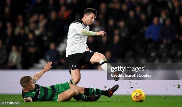 David Nugent of Derby is tackled by Jake Bidwell of QPR during the Sky Bet Championship match between Derby County and Queens Park Rangers at iPro...