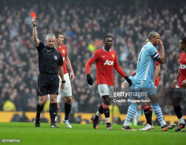 Vincent Kompany of Manchester City is shown the red card by referee Chris Foy after his two footed tackle on Nani of Manchester United during the FA...