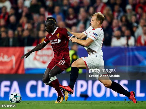 Johannes Geis of Sevilla FC duels for the ball with Sadio Mane of Liverpool FC during the UEFA Champions League group E match between Sevilla FC and...