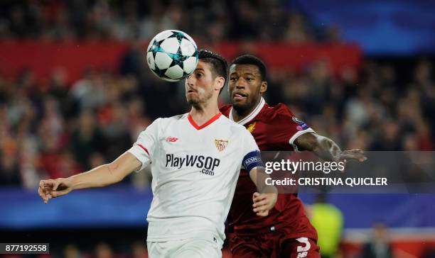 Sevilla's defender Sergio Escudero vies with Liverpool's Dutch midfielder Georginio Wijnaldum on November 21, 2017 at the Ramon Sanchez Pizjuan...