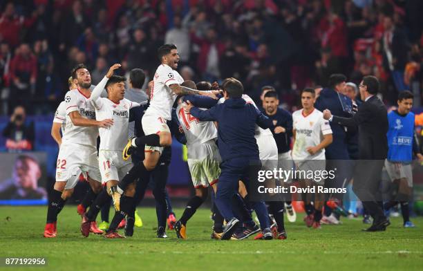 Guido Pizarro of Sevilla celebrates with team mates and staff members after scoring his sides third goal during the UEFA Champions League group E...