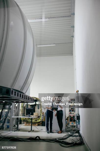 trainee pilot examining a flight simulator with instructor - pilot simulator stock pictures, royalty-free photos & images