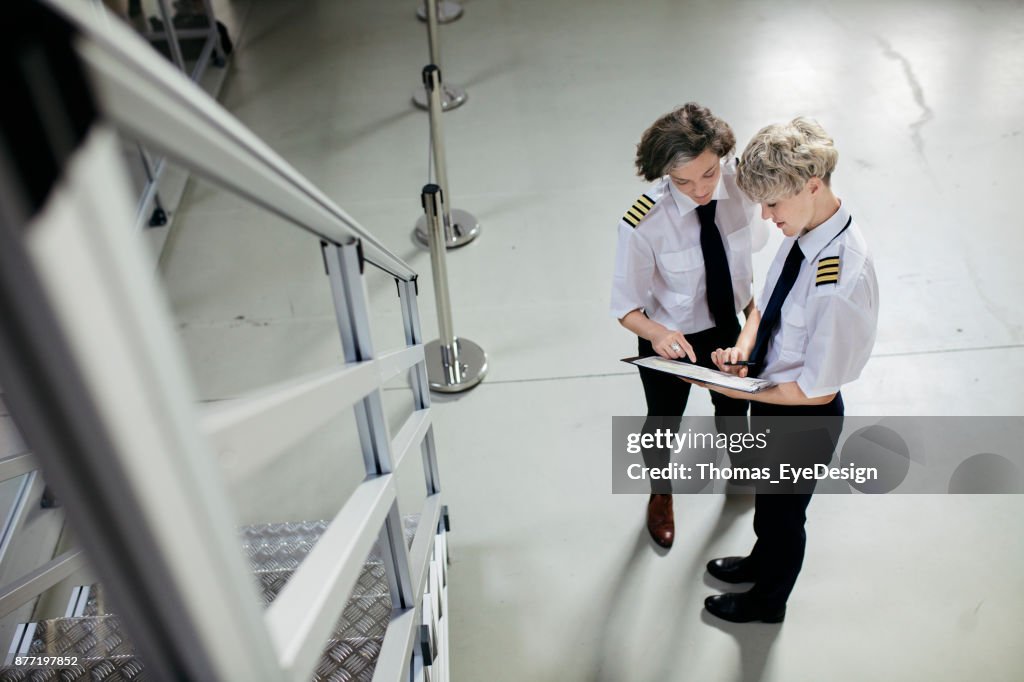 Flight Instructin Flight Instructor Going Over Map With Trainee Pilot Before Training ...
