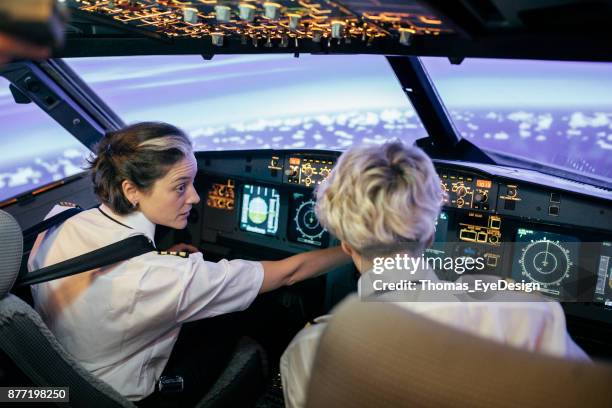 instructor de vuelo que marca y muestra al piloto aprendiz - simulador de vuelo fotografías e imágenes de stock