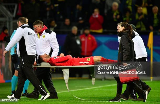 Dortmund's Swiss goalkeeper Roman Buerki is stretchered off by medical staff during the UEFA Champions League Group H football match BVB Borussia...