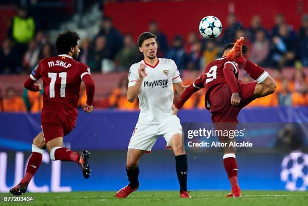 Clement Lenglet of Sevilla FC duels for the ball with Roberto Firmino of Liverpool FC during the UEFA Champions League group E match between Sevilla...
