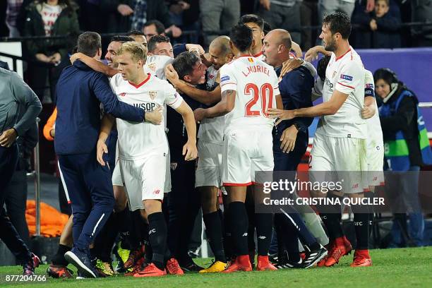 Sevilla's Argentinian midfielder Guido Pizarro celebrates with Sevilla's Argentinian coach Eduardo Berizzo after scoring a goal on November 21, 2017...