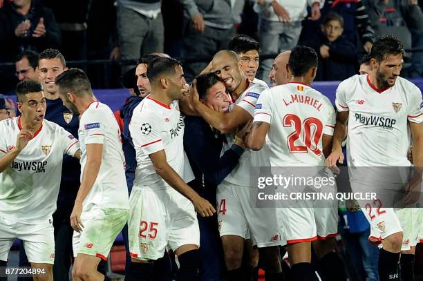 Sevilla's Argentinian midfielder Guido Pizarro celebrates with Sevilla's Argentinian coach Eduardo Berizzo after scoring a goal on November 21, 2017...