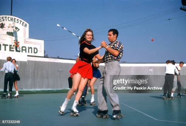 General view of Gloria dancing with a friend while roller skating circa November, 1954 at the Westchester SkateLand in Westchester, New York.