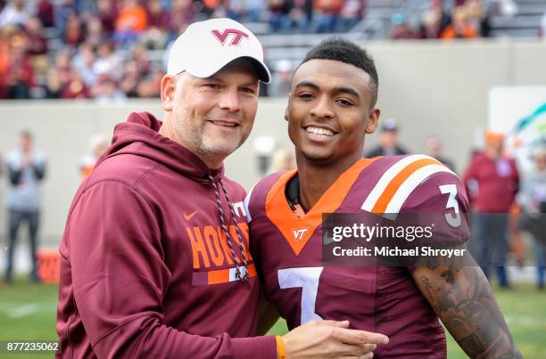 Cornerback Greg Stroman of the Virginia Tech Hokies poses for a photo with head coach Justin Fuente during the senior ceremony prior to the game...