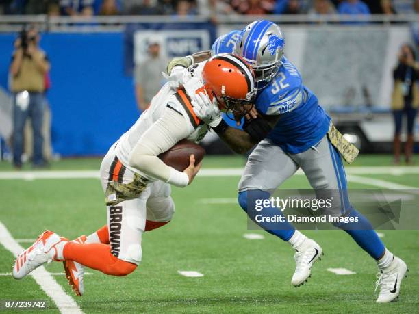 Quarterback Cody Kessler of the Cleveland Browns is sacked by safety Tavon Wilson of the Detroit Lions in the fourth quarter of a game on November...