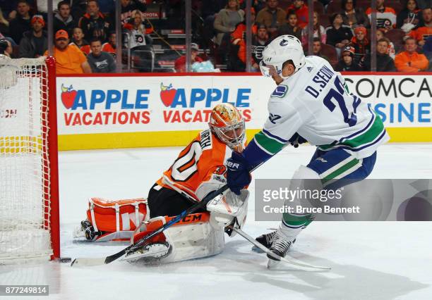 Daniel Sedin of the Vancouver Canucks scores at 9:42 of the first period against Michal Neuvirth of the Philadelphia Flyers at the Wells Fargo Center...