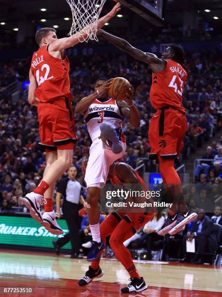 Bradley Beal of the Washington Wizards drives to the basket as Jakob Poeltl, OG Anunoby and Pascal Siakam of the Toronto Raptors defend during the...