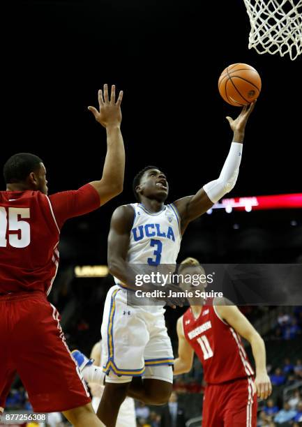 Aaron Holiday of the UCLA Bruins shoots during the National Collegiate Basketball Hall Of Fame Classic consolation game against the Wisconsin Badgers...