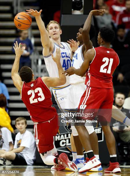 Thomas Welsh of the UCLA Bruins blocks a shot by Kobe King of the Wisconsin Badgers during the National Collegiate Basketball Hall Of Fame Classic...