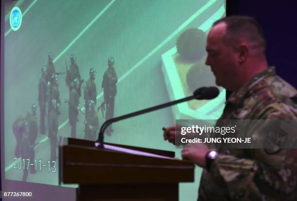 United Nations Command spokesman Colonel Chad G. Carroll shows a surveillance TV footage containing the moment of defection of a North Korean...