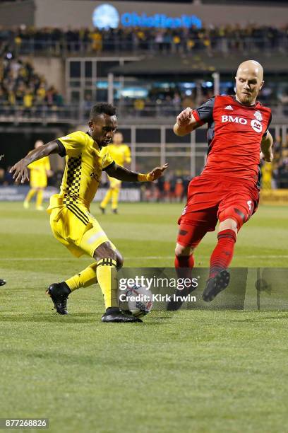 Harrison Afful of the Columbus Crew SC attempts to move the ball past Michael Bradley of the Toronto FC during the first half at MAPFRE Stadium on...