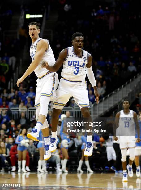 Aaron Holiday of the UCLA Bruins celebrates with Alex Olesinski after winning the National Collegiate Basketball Hall Of Fame Classic consolation...