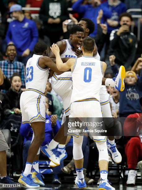Aaron Holiday of the UCLA Bruins is mobbed by teammates after making a three-pointer at the end of the National Collegiate Basketball Hall Of Fame...