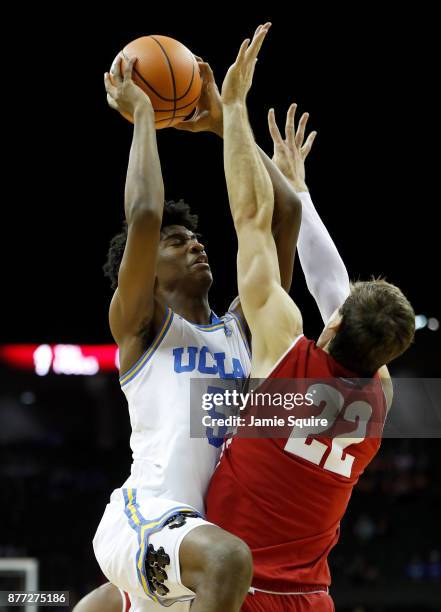 Chris Smith of the UCLA Bruins shoots over Ethan Happ of the Wisconsin Badgers during the National Collegiate Basketball Hall Of Fame Classic...