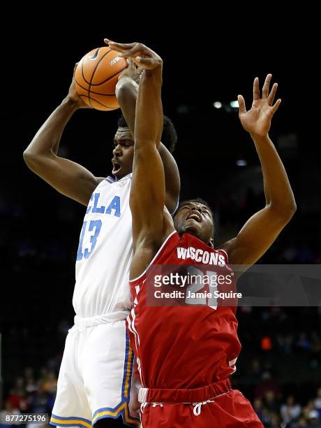 Kris Wilkes of the UCLA Bruins battles Khalil Iverson of the Wisconsin Badgers for a rebound during the National Collegiate Basketball Hall Of Fame...