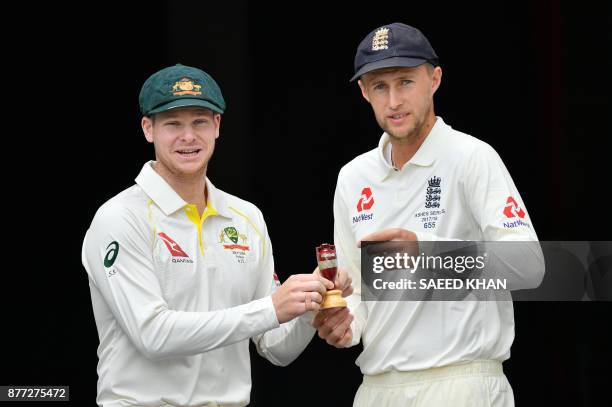 Australia's skipper Steve Smith and Joe Root, Captain of England smile as they pose at a media opportunity in Brisbane on November 22 ahead ahead of...