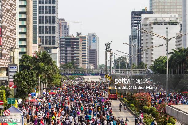 a huge crowd attends the car free day along sudirman street in jakarta, indonesia capital city - sudirman stock pictures, royalty-free photos & images