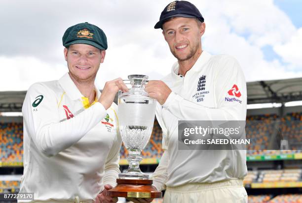 Australia's skipper Steve Smith and England captain Joe Root smile as they pose at a media opportunity in Brisbane on November 22 ahead of the first...