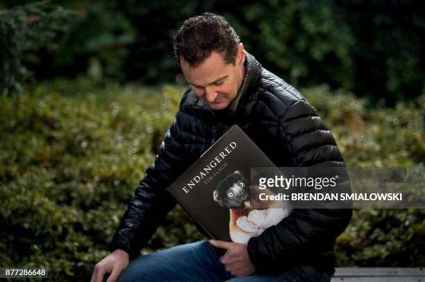 London-based photographer Tim Flach poses with his book "Endangered" November 13, 2017 in Washington, DC. - As a child, Tim Flach would immerse...