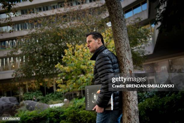 London-based photographer Tim Flach poses with his book "Endangered" November 13, 2017 in Washington, DC. - As a child, Tim Flach would immerse...