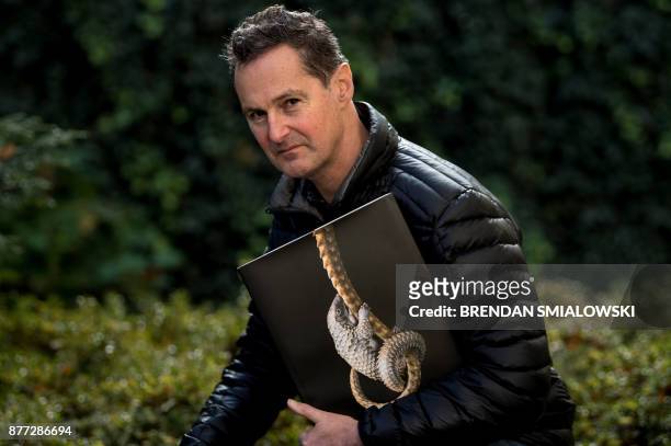 London-based photographer Tim Flach poses with his book "Endangered" November 13, 2017 in Washington, DC. - As a child, Tim Flach would immerse...