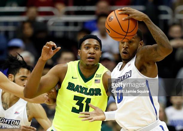 Marcus Foster of the Creighton Bluejays and Terry Maston of the Baylor Bears compete for a loose ball during the National Collegiate Basketball Hall...
