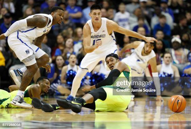 Marcus Foster and Martin Krampelj of the Creighton Bluejays scramble alongside Terry Maston of the Baylor Bears for a loose ball during the National...