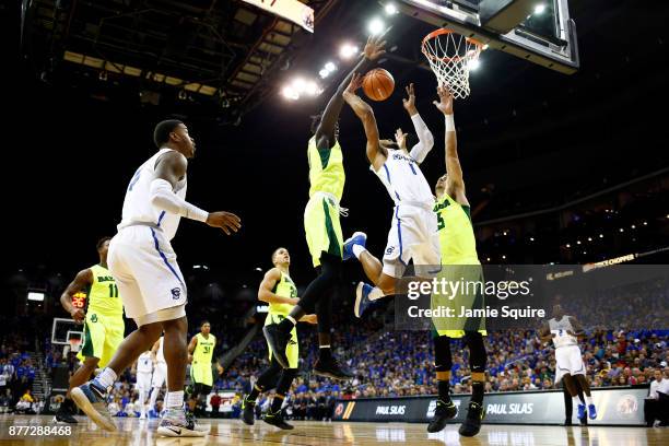 Davion Mintz of the Creighton Bluejays loses the ball as he goes up on a fast break as Jo Lual-Acuil Jr. #0 and Jake Lindsey of the Baylor Bears...