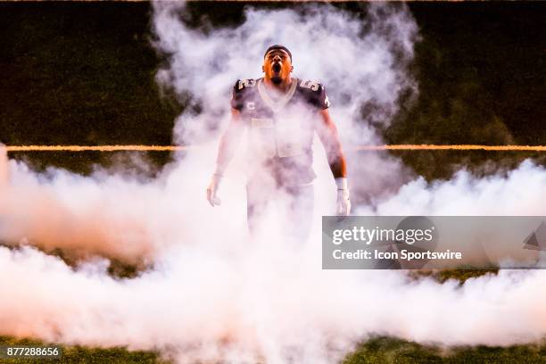 New Orleans Saints linebacker Craig Robertson runs out through the smoke against Washington Redskins on November 19, 2017 at the Mercedes-Benz...