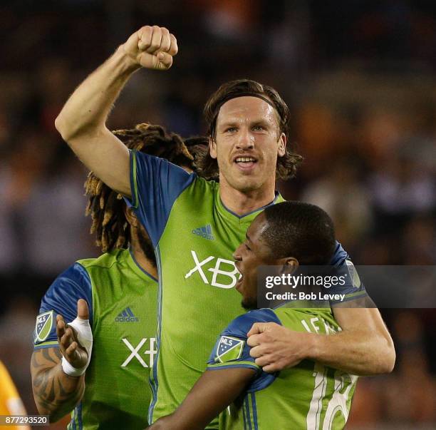 Gustav Svensson of Seattle Sounders celebrates with Kelvin Leerdam and Roman Torres after scoring against the Houston Dynamo in the first half at...