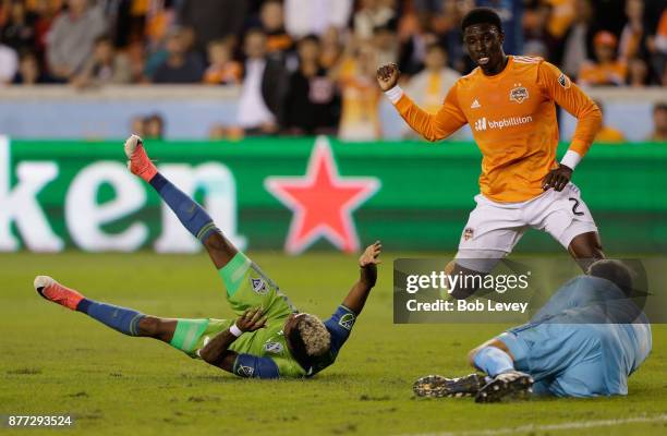 Joevin Jones of Seattle Sounders is tackled in the penalty area by Jalil Anibaba of Houston Dynamo in the first half at BBVA Compass Stadium on...